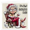 Funny Christmas card featuring a glamorous Mrs Claus relaxing in an armchair with a glass of red wine, surrounded by empty bottles and glasses, with the caption “Phew! Boxing Day”.