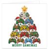 Colourful gamer Christmas card featuring a festive tree made from stacked retro-style gaming controllers decorated with Christmas lights, snowflakes, baubles, presents, reindeer antlers, bells and a Santa hat. A gold star tops the controller tree against a clean white background. Large green text underneath reads “MERRY GAMEMAS”, creating a funny Christmas gaming pun for male and female gamers.