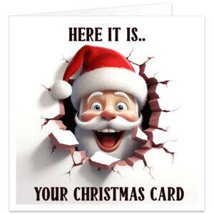 Funny Christmas card featuring a cheerful cartoon Santa Claus bursting through a cracked wall with a playful 3D effect. Front text reads "HERE IT IS.. YOUR CHRISTMAS CARD". Blank inside, professionally printed on premium 300gsm matte cardstock with envelope included.