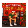 Funny Christmas card for a male gym-goer featuring the text “Merry Christmas, You Fit Legend”. Colourful illustration of a muscular man in a Santa hat sitting on a gym bench, flexing his arm and holding a protein shaker. Surrounded by dumbbells, kettlebells, weights and gym equipment, with a decorated Christmas tree, presents, wreath, garlands, baubles and festive lights on a bright red background.