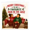 Funny Husband Christmas card featuring the text “Merry Christmas to My Favourite Pain in the Arse” in red and green lettering with holly and hearts. Illustrated husband and wife sit together on a sofa in festive pyjamas beside a decorated Christmas tree, fairy lights and presents. Their tops read “Still Wouldn’t Change a Thing” and “Lucky Bastard”, with mugs and a “My Favourite Human” cushion completing the cosy, cheeky Christmas scene.