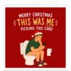 Funny Christmas card showing a man in a Santa hat sitting on the toilet with his trousers down while scrolling on his phone, with the message “Merry Christmas – This Was Me Picking This Card” on a red festive background.