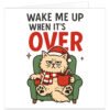 Funny cat Christmas card featuring a grumpy fluffy cat slumped in a green armchair, wearing a red Santa hat and striped festive scarf while holding a red mug with a candy cane. Bold black and red text above reads “Wake Me Up When It’s Over”, with small red and green star details on a white background. Humorous festive card for a cat owner, cat lover, mum or dad.