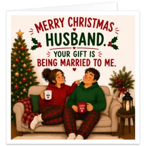 Funny Husband Christmas card featuring a cosy illustrated married couple relaxing on a sofa in matching red and green tartan pyjamas beside a decorated Christmas tree. The wife points playfully at her husband as they hold mugs. Front text reads “Merry Christmas Husband” and “Your Gift Is Being Married to Me”. Festive details include holly, baubles, fairy lights, greenery, berries, hearts, cushions and a candle lantern.