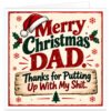 Funny rude Christmas card for Dad featuring the text “Merry Christmas Dad. Thanks for Putting Up With My S**t.” Bold red and dark green typography on a warm cream background with a rustic wooden sign, Santa hat, holly and berries, snowflakes and Christmas tree. Festive retro-style Dad Christmas card with cheeky adult humour, designed as a funny card from a son or daughter.
