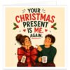 Funny Husband Christmas card with the message “Your Christmas Present Is Me. Again.” in red and green lettering. Festive illustration shows a wife in red tartan pyjamas wrapped in a large gift bow marked “Handle With Love”, beside her smiling husband holding a “Best Gift Ever” mug. Holly, red berries, hearts and stars decorate the pale cream background.