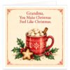 Sentimental Grandma Christmas card featuring the heartfelt message "Grandma, You Make Christmas Feel Like Christmas" in elegant red lettering. Charming illustration of a cosy red mug decorated with white snowflakes, filled with hot chocolate, marshmallows and cinnamon sticks, surrounded by festive holly, red berries and a star-shaped biscuit. Soft cream background with a vintage-inspired border. Available in Grandma, Granny, Nanny and Nan variations.